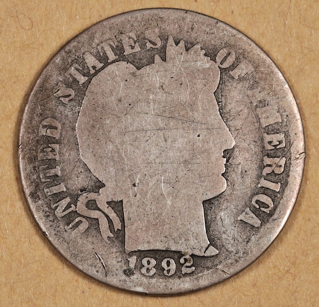 1892 Barber dime die clash or cud error showing raised metal blob at rim from die break